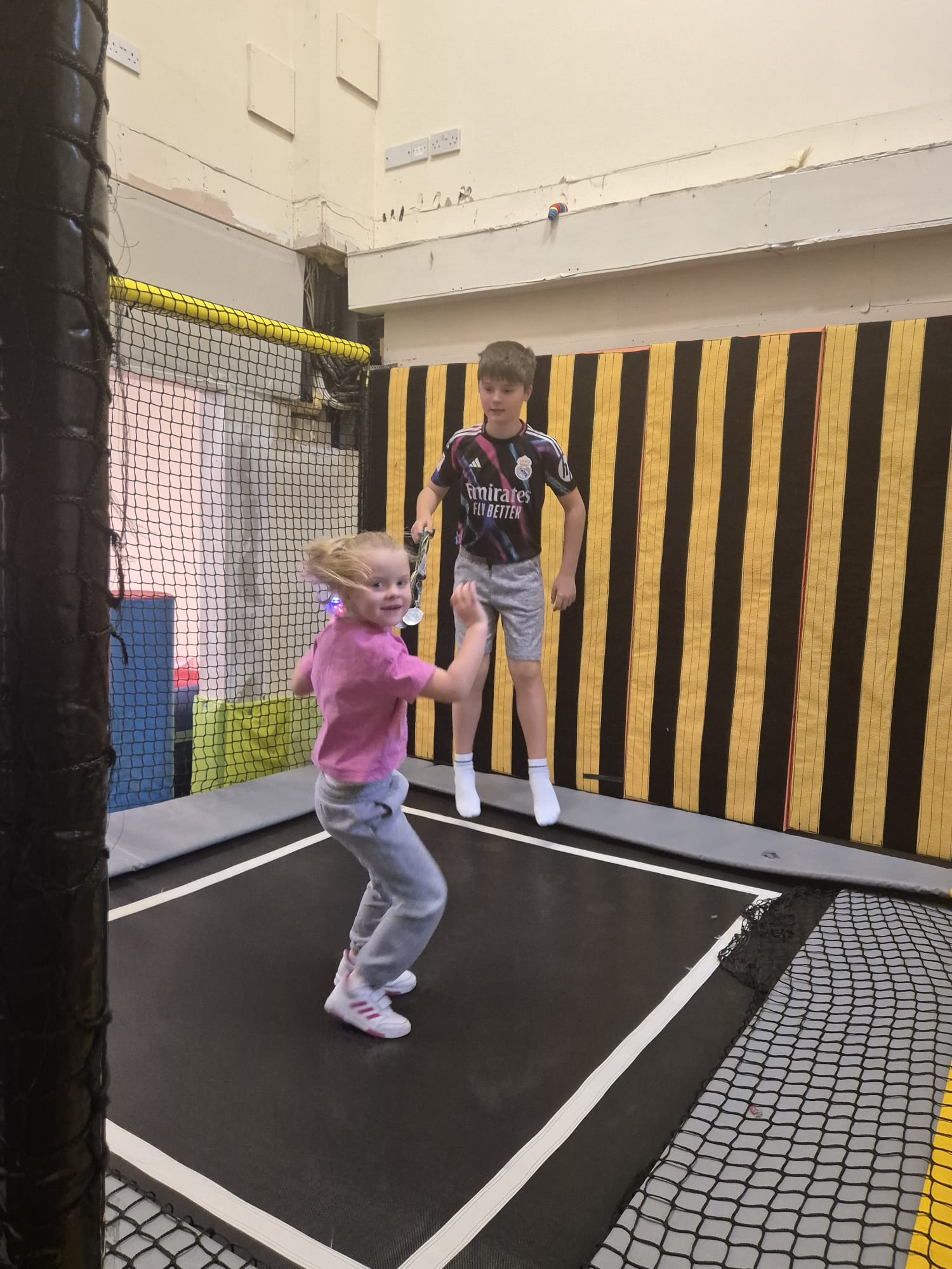 Two children bouncing on trampolines at the ASD Ireland summer camp.